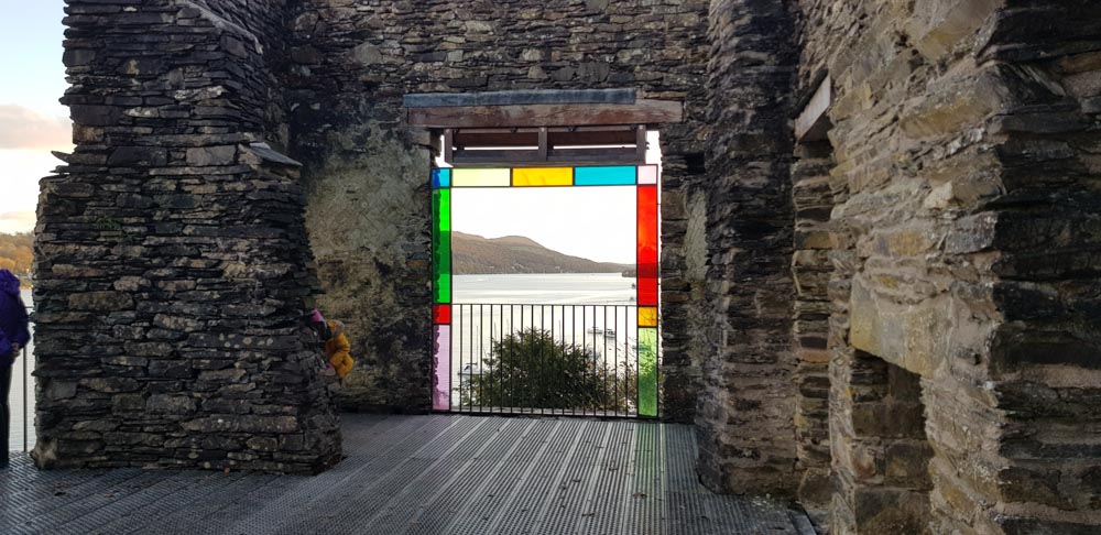 View of a lake framed by panels of coloured glass