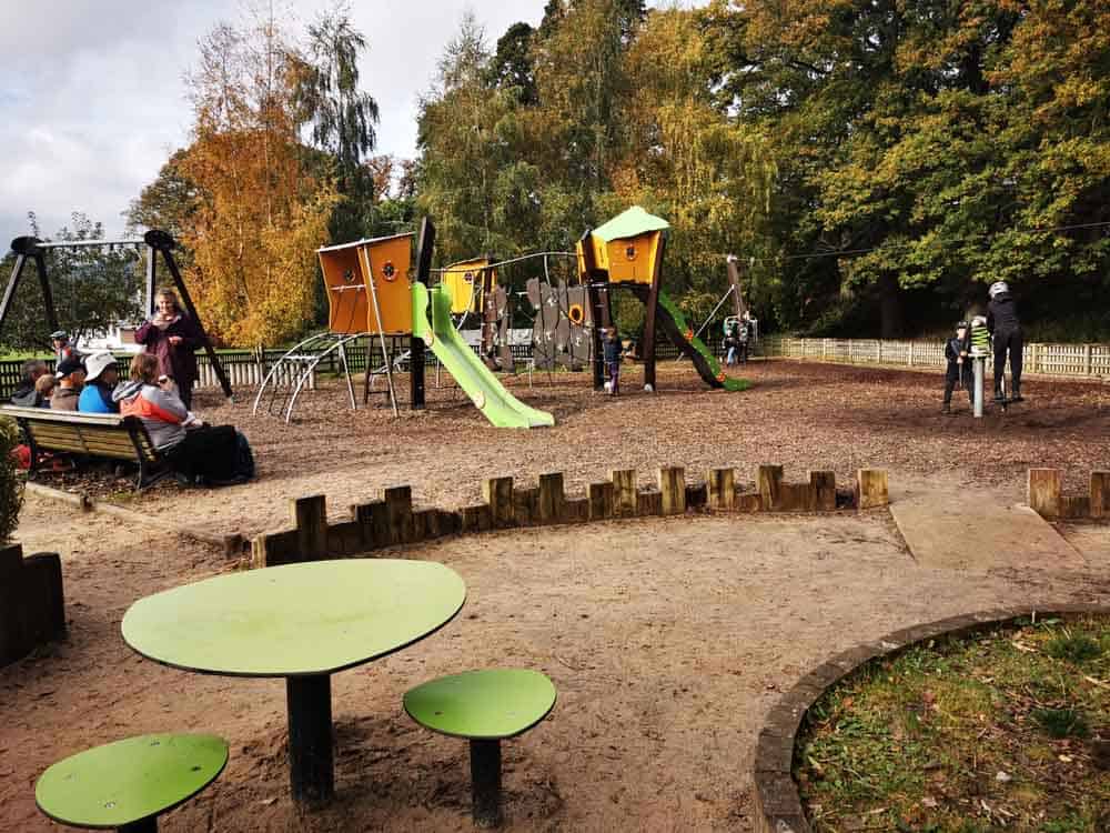 Picnic table and then kids play area in the background