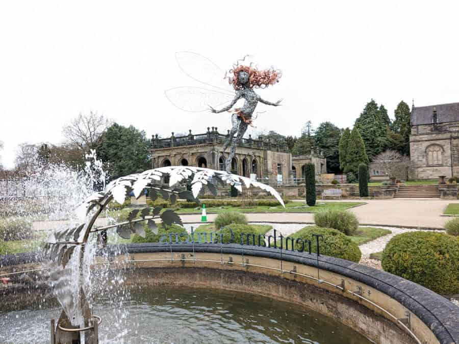 Fairy sculpture in a fountain in formal gardens