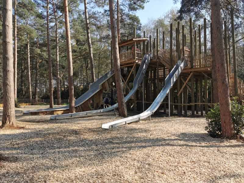 Large slides on woodedn play frame