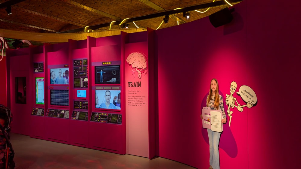 Pink wall and lots of screens and dials