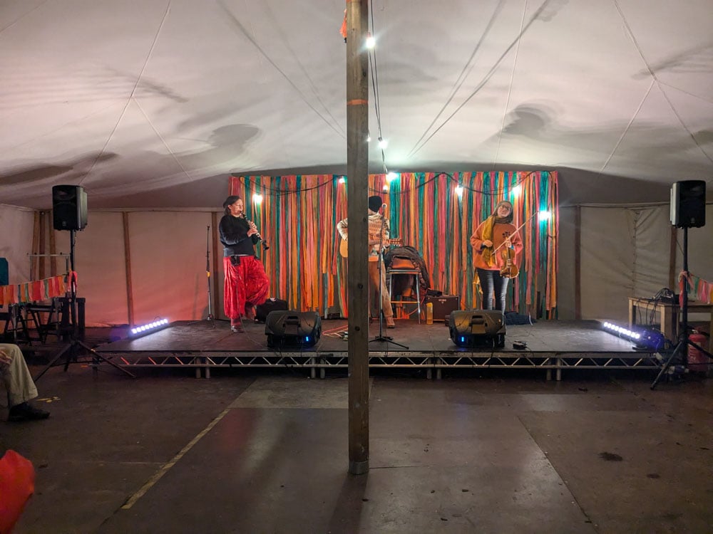 Group of musicians on a stage in a marquee