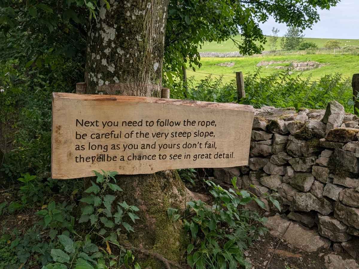 Wooden sign with a poem carved on it