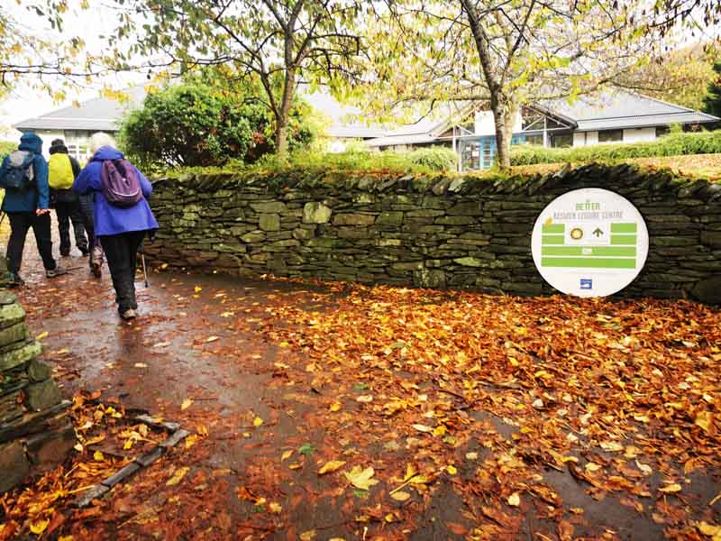 people walking a long a path in autumn