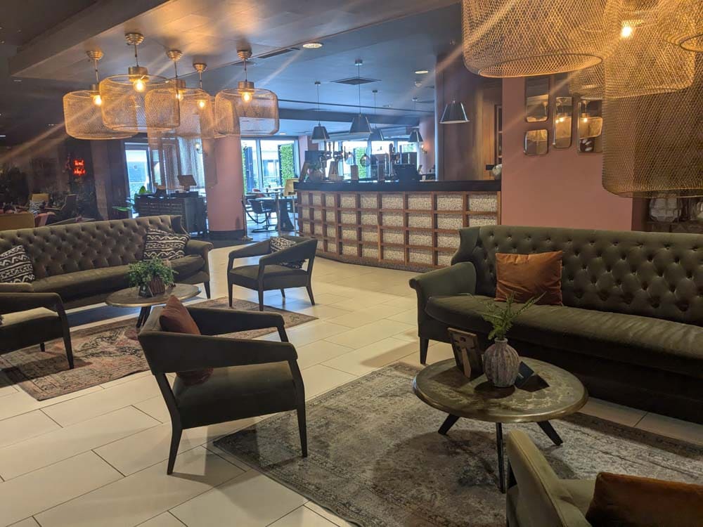 Green sofas in a pink bar