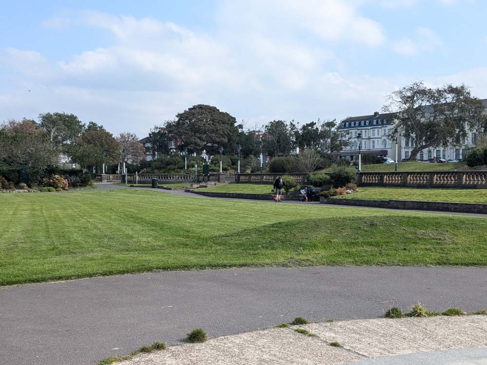 Large grass area with flower area beyond