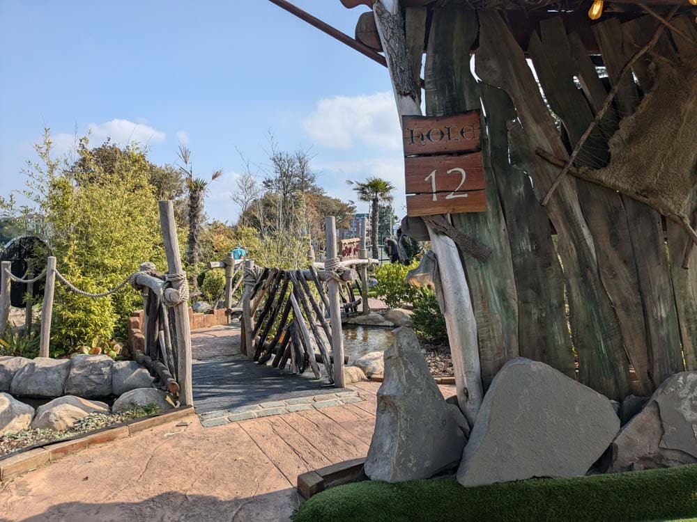 Viking themed adventure golf hole with wooden elements and planting