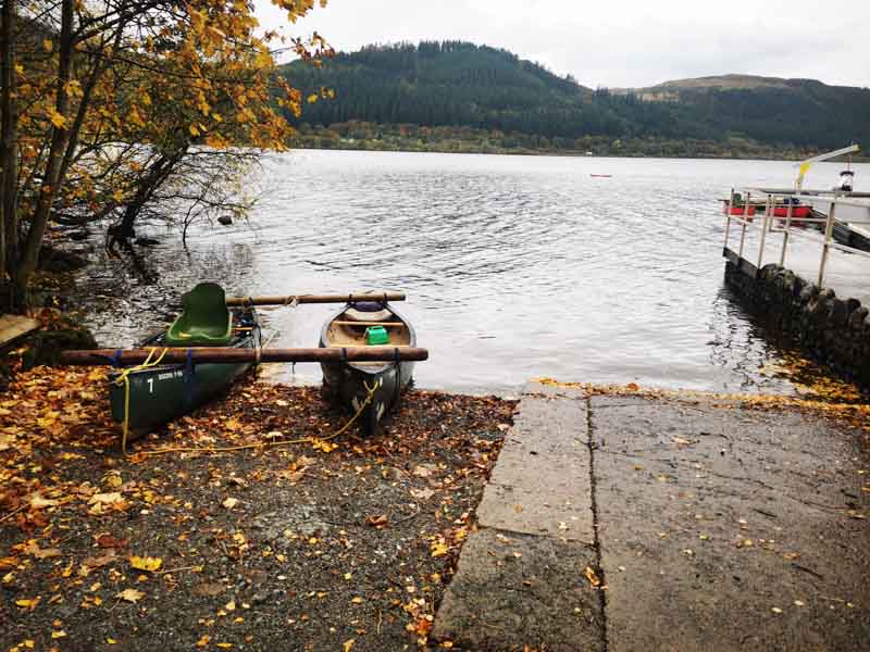 Canoes next to a lake
