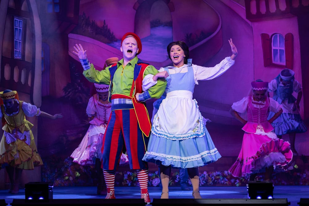 man and woman on stage in panto costumes