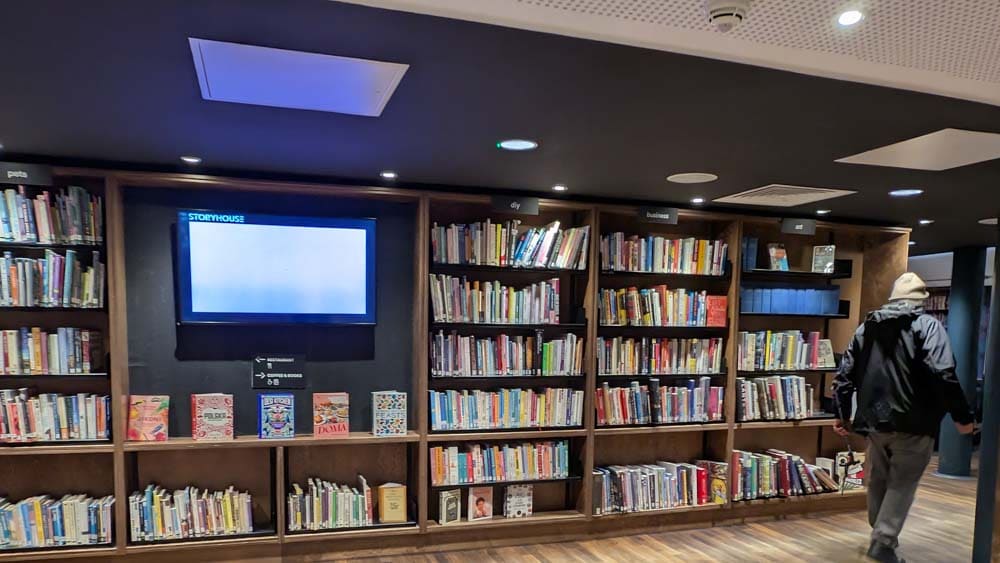 Rows of book cases and a tv screen