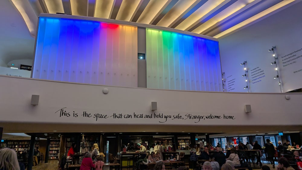 Colourful lights above a row of bookshelves