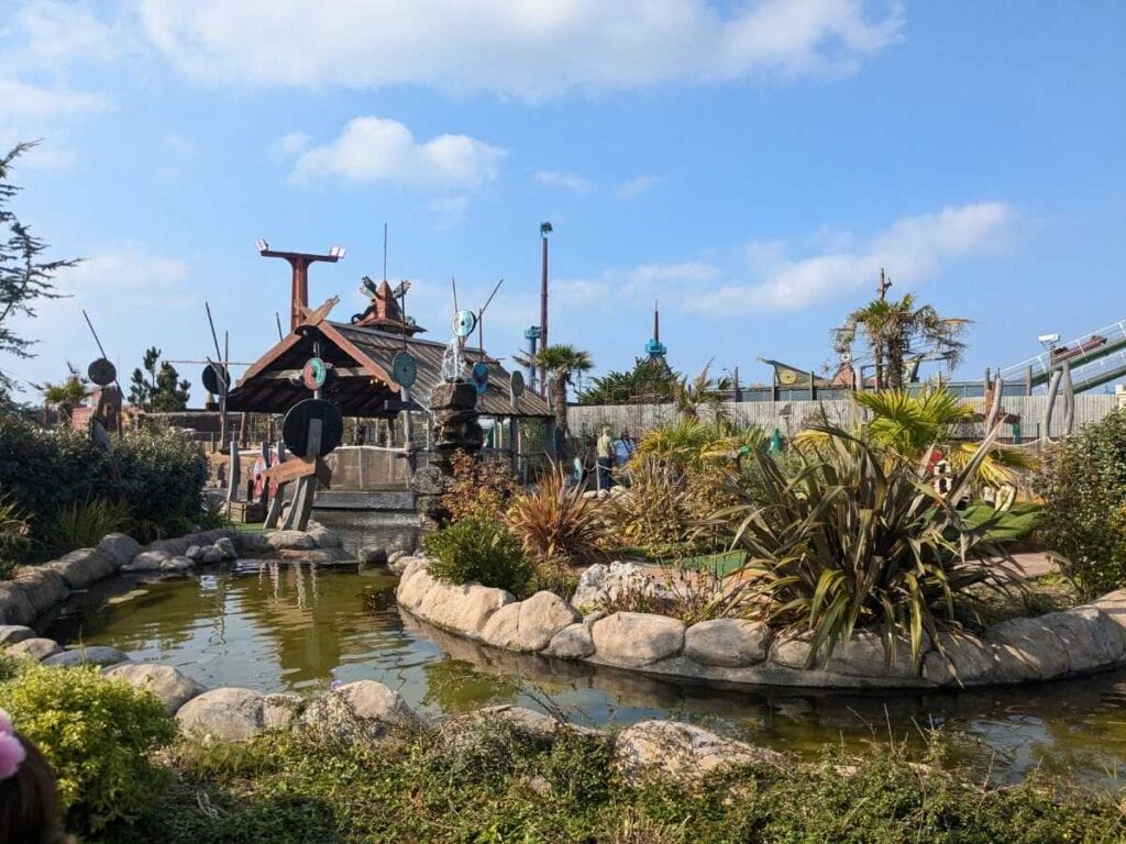 Pond and planting with wooden Viking hut behind