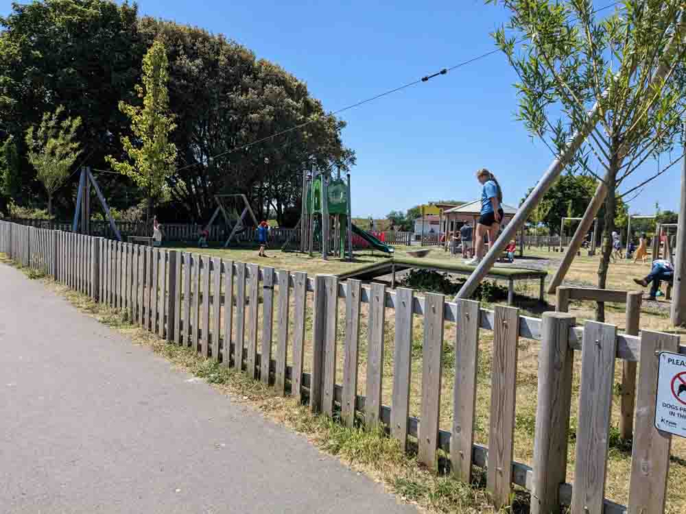 Fenced park with zip wire behind