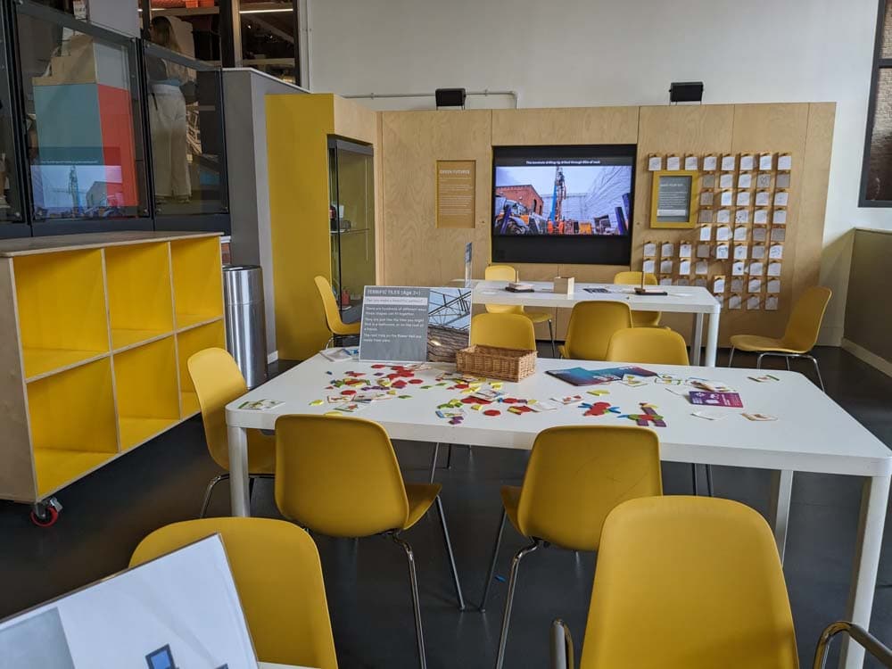 white tables with games on them and yellow chairs around them