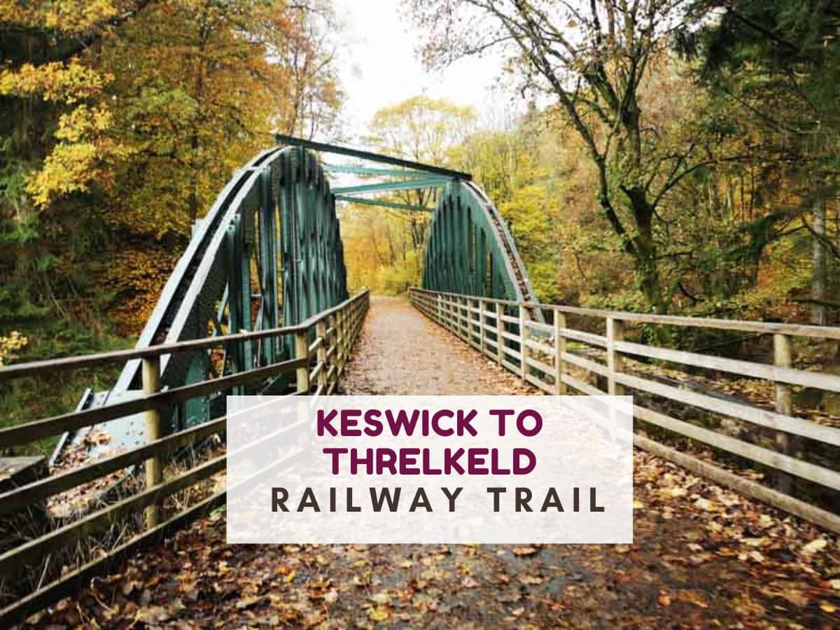 Large green metal arches on a bridge. Text reads Keswick to Threlkeld railway path