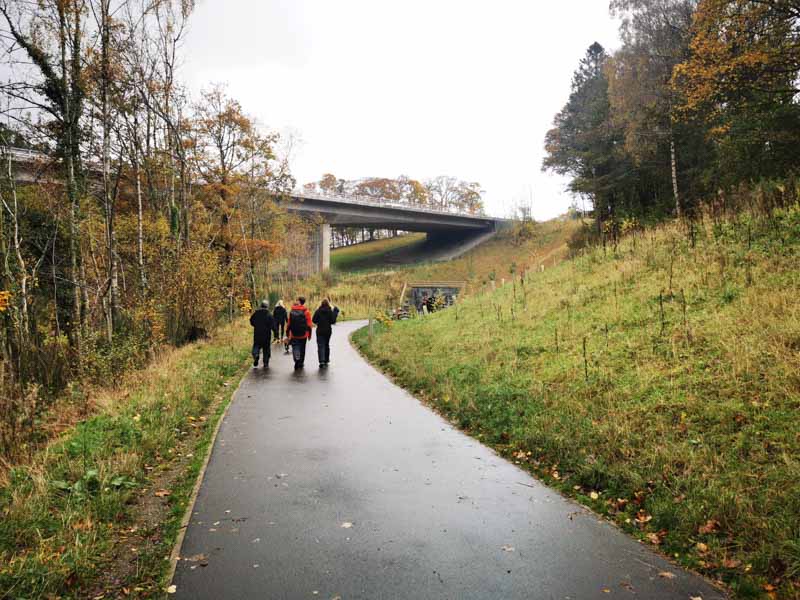People walking towards a tunnel