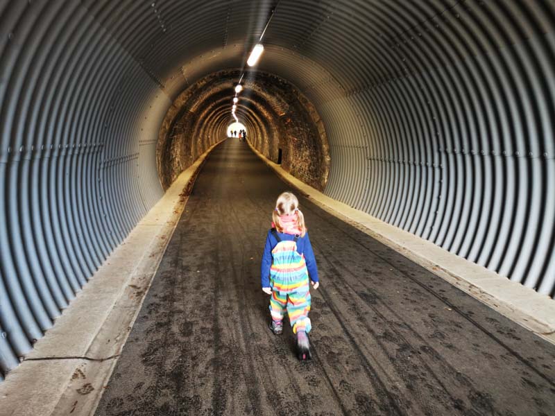 Child walking through tunnel