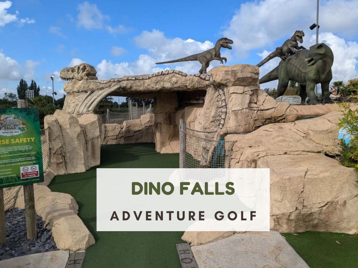 Large yellow stone tunnel with dinosaur on top. Text reads Dino Falls adventure golf
