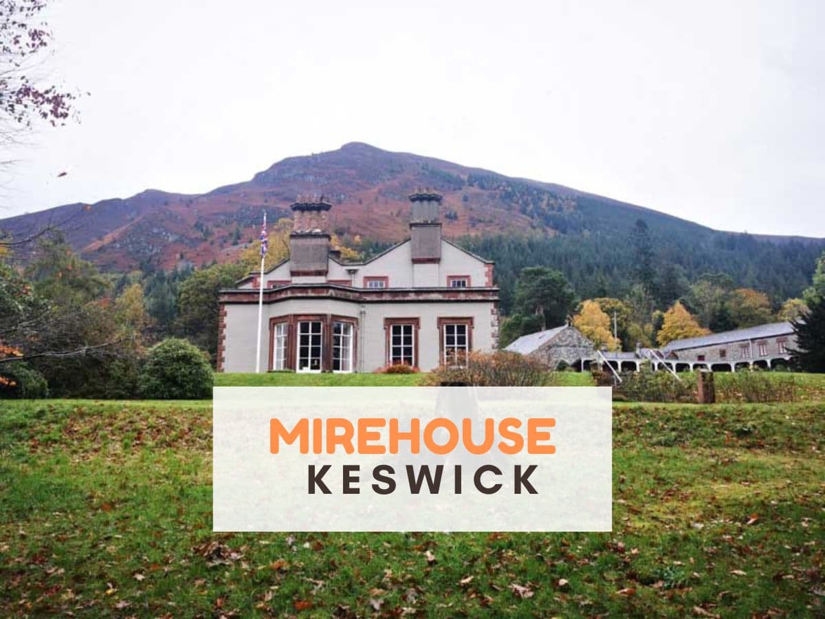 Big White house with mountains behind. Text reads Mirehouse Keswick