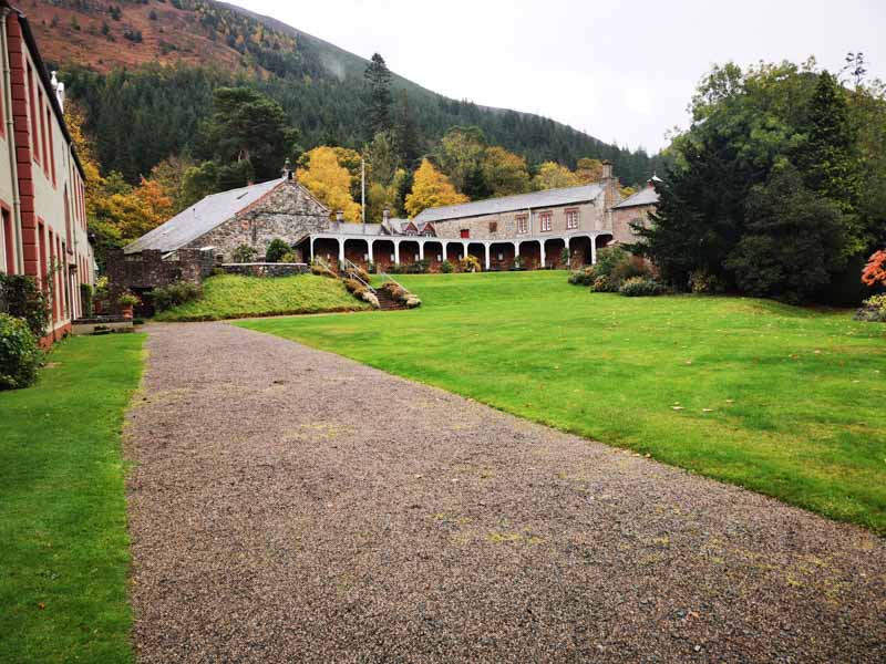 Back of a house with lawns and a path